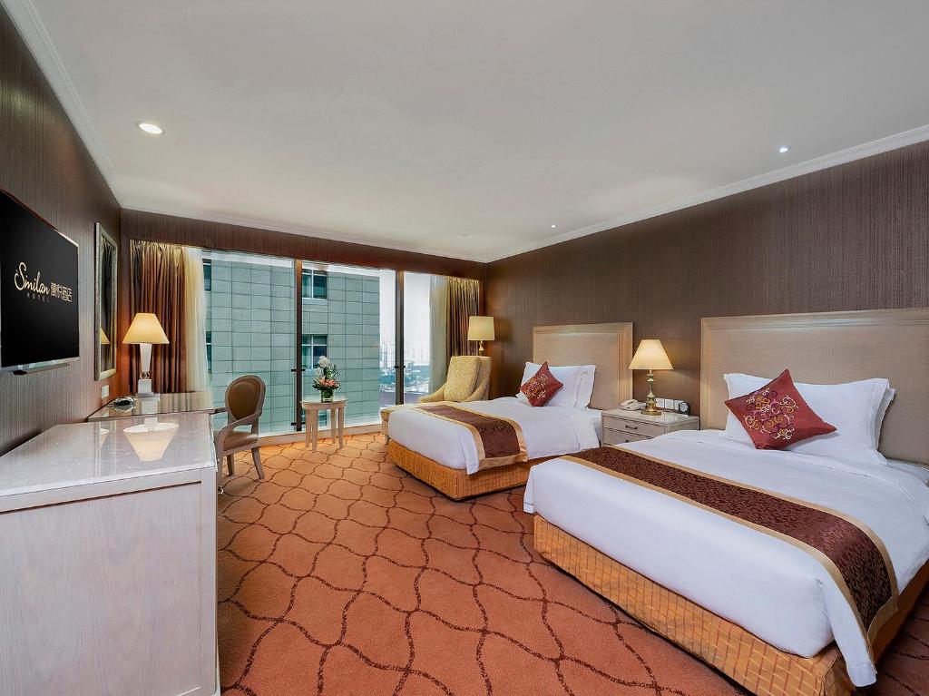 Postel nebo postele na pokoji v ubytování Similan Hotel Zhuhai-Gongbei Port