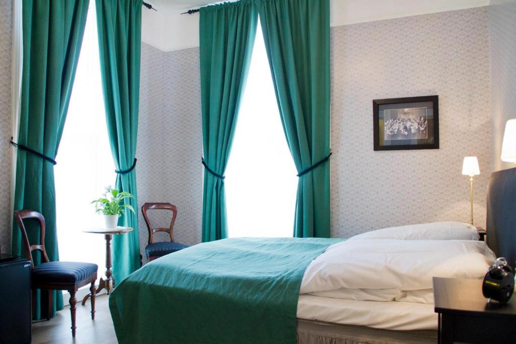 Postel nebo postele na pokoji v ubytování Hotel Kong Carl - Unike Hoteller
