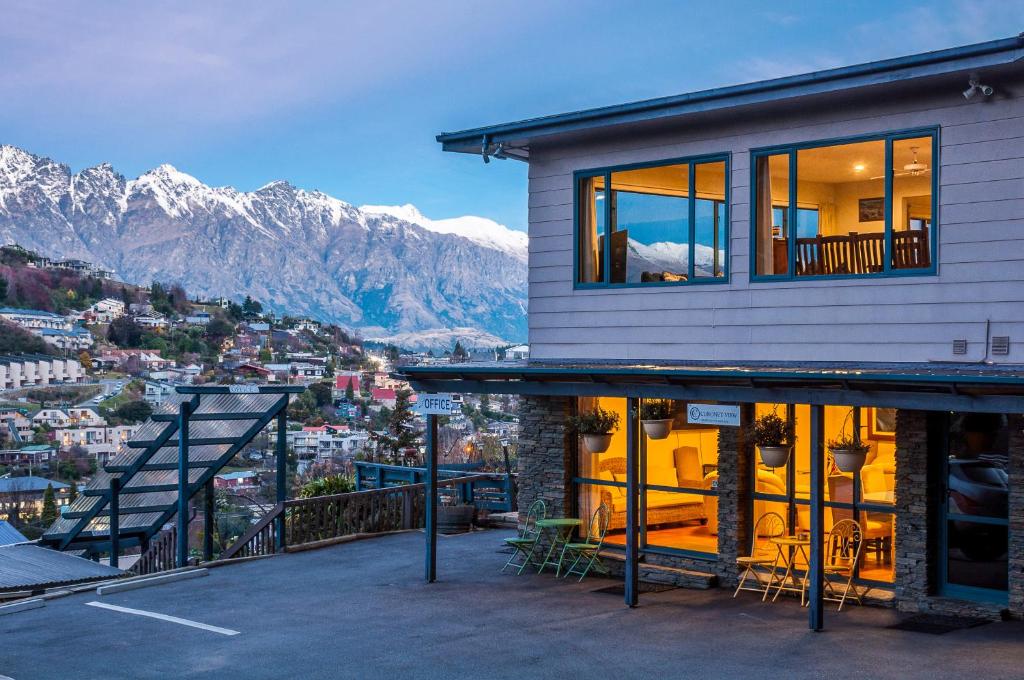 a house with a balcony with a view of mountains at Coronet View Accommodation in Queenstown