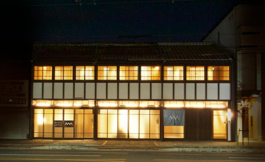 a building with lit up windows at night at 壬生宿 MIBU-JUKU Shichijo-Umekoji in Kyoto