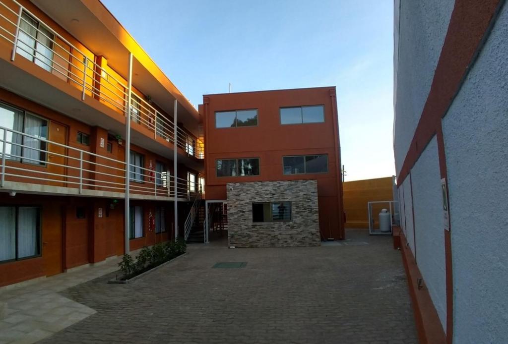 a large building with a brick courtyard in front of it at Hotel Doña Esperanza in Calama