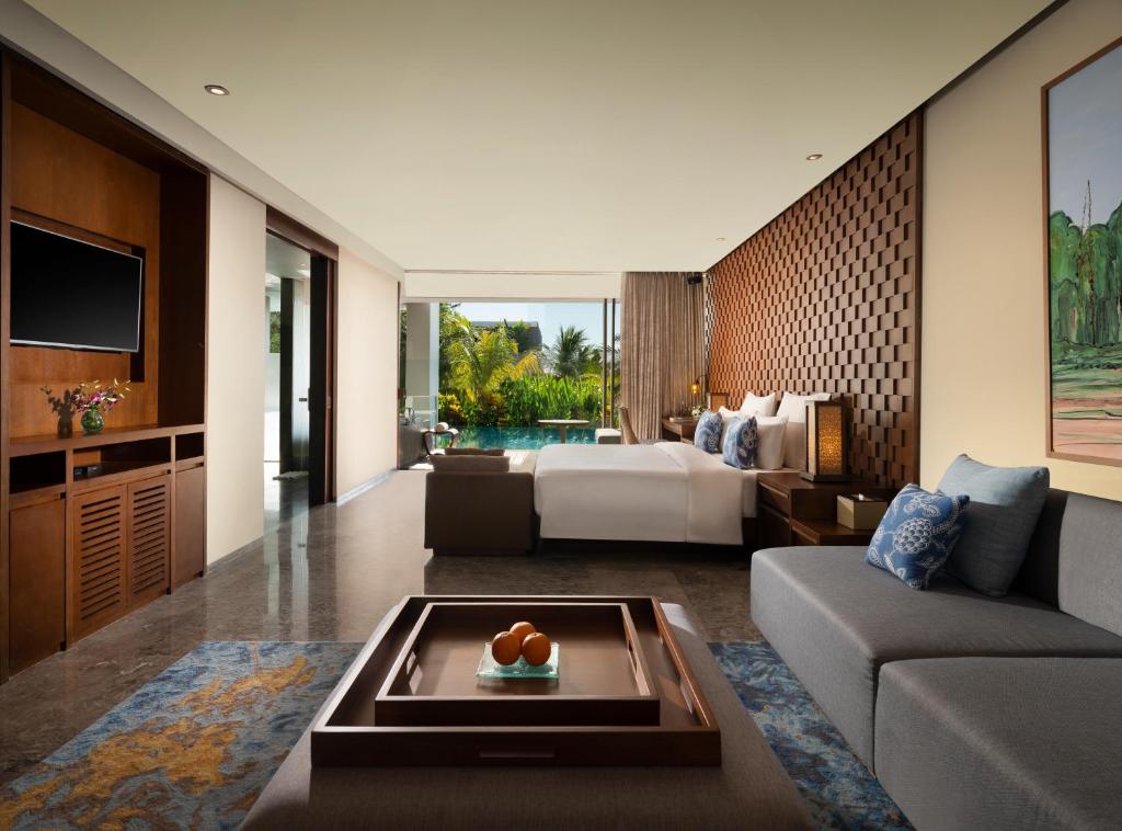 a living room with a couch and a bed at Anantara Uluwatu Bali Resort in Uluwatu