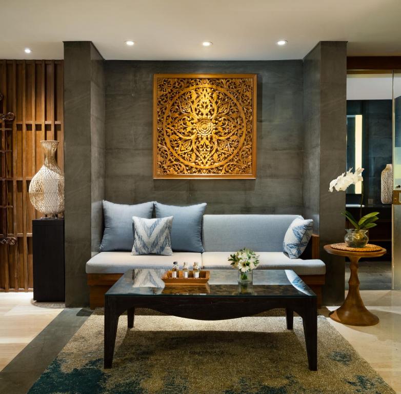 a living room with a couch and a coffee table at Anantara Uluwatu Bali Resort in Uluwatu
