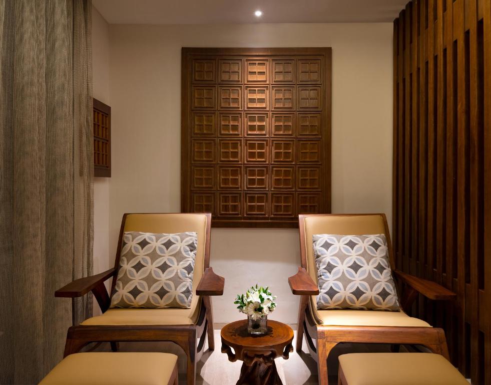 two chairs and a table in a room at Anantara Uluwatu Bali Resort in Uluwatu
