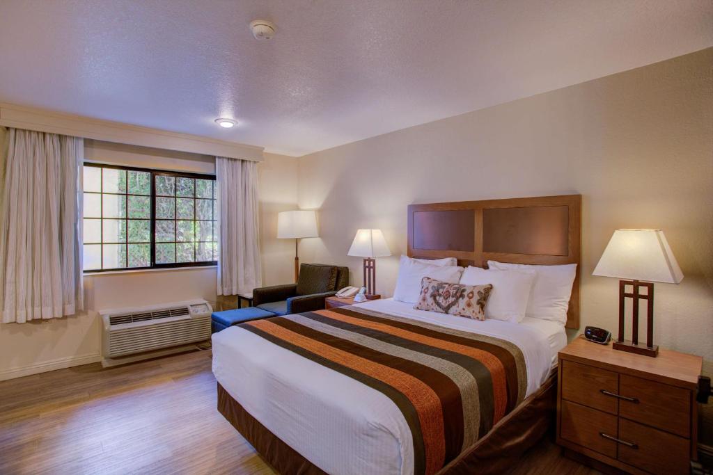 a hotel room with a large bed and a window at Best Western Sandman Hotel in Sacramento
