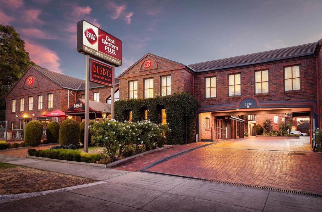 a large brick building with a sign in front of it at Best Western Plus Buckingham International in Moorabbin
