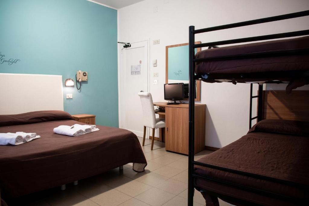 Postel nebo postele na pokoji v ubytování Hotel Vela D'Oro