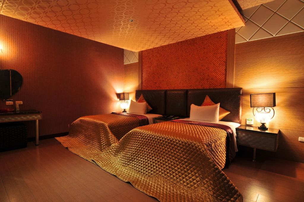 Postel nebo postele na pokoji v ubytování Zheng Yi Hotel & Motel I