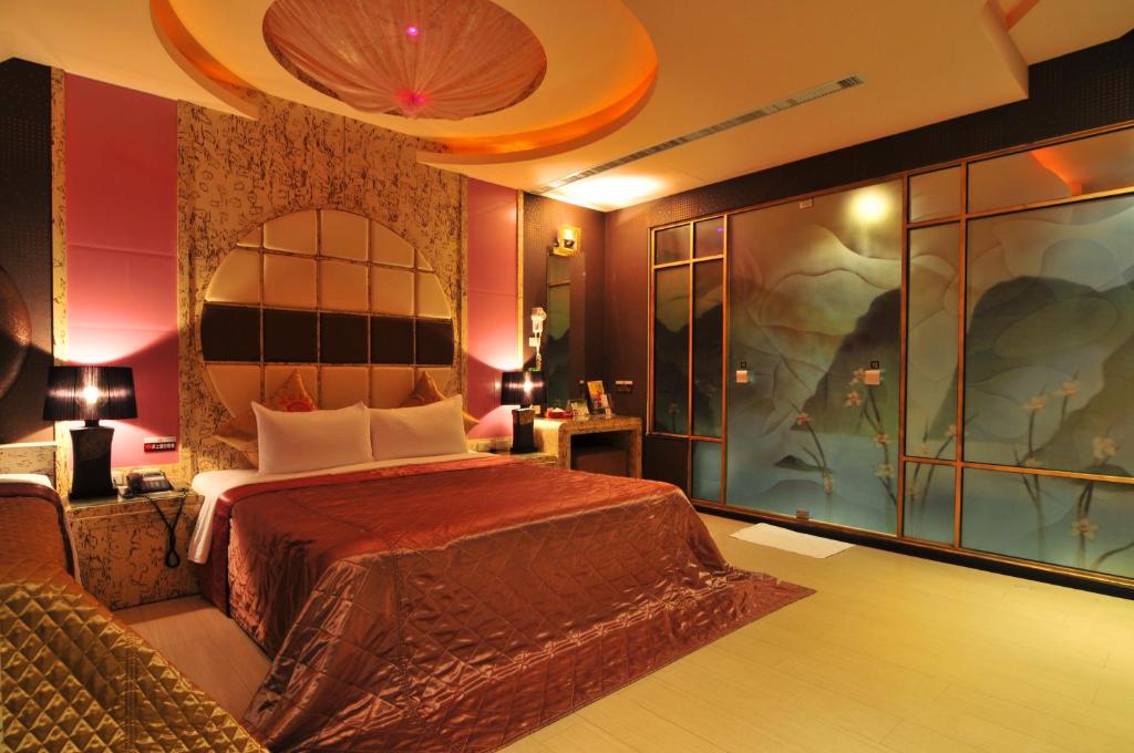 Postel nebo postele na pokoji v ubytování Zheng Yi Hotel & Motel I