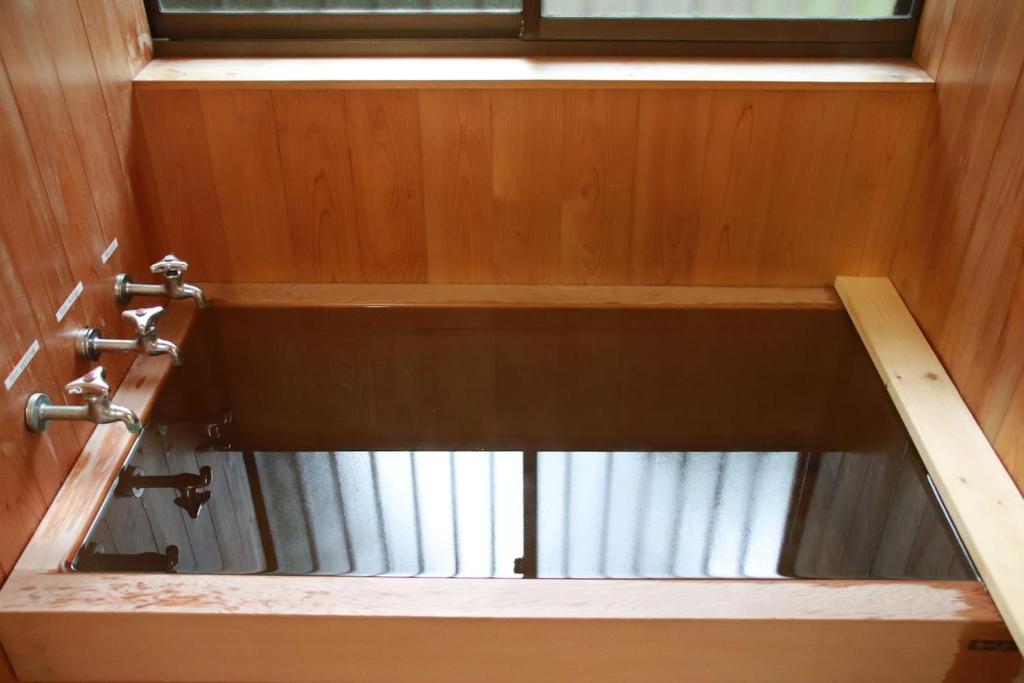 a view from the inside of a bathroom with a window at Yamaguchi House Annex, Private House with Onsen in Hakone