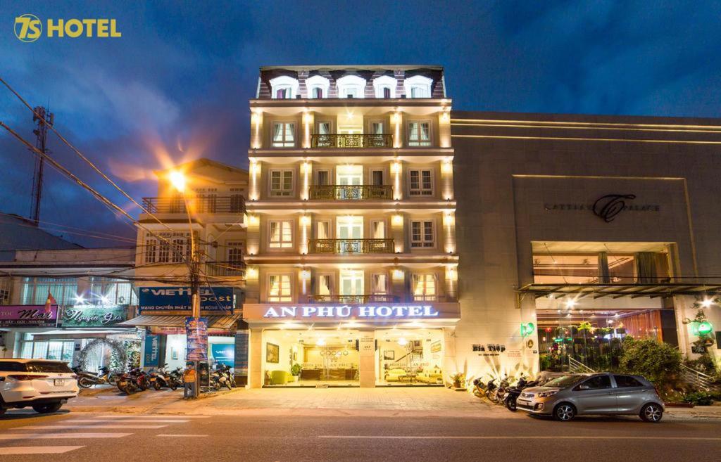 a building with a sign on the side of a street at An Phu Hotel Da Lat in Da Lat