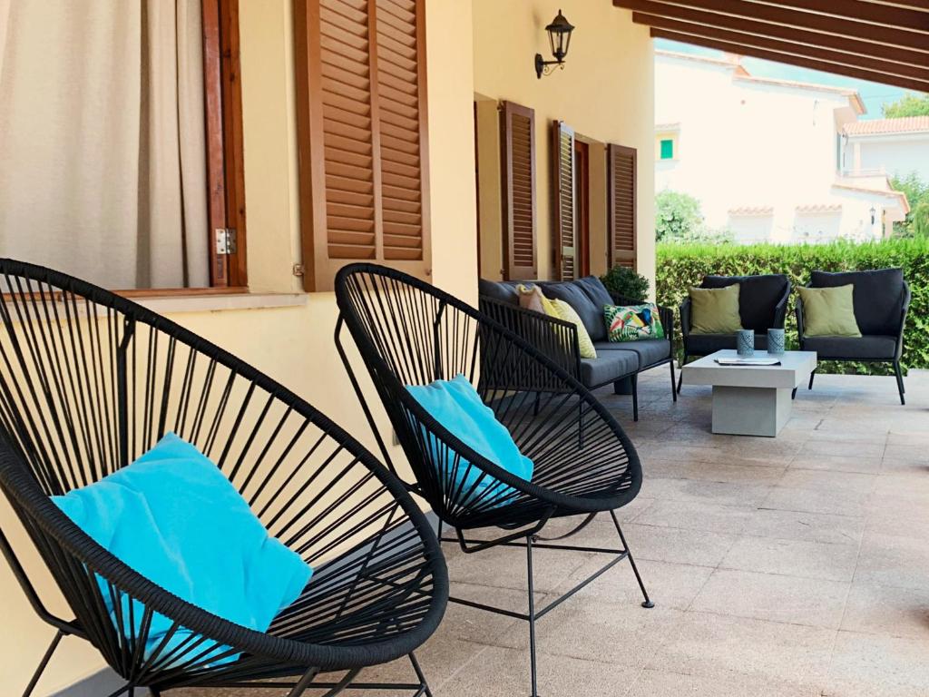 two chairs with blue pillows sitting on a patio at Casa Coromines in Alcudia