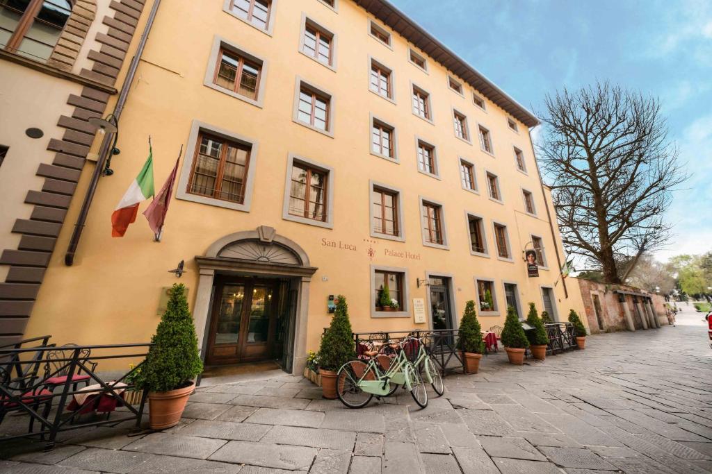 a building with a bike parked in front of it at San Luca Palace in Lucca