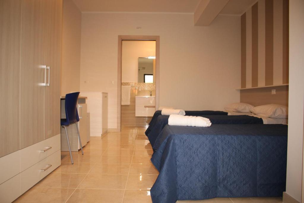 a bedroom with two beds and a television in it at Villa Angela in Scalea