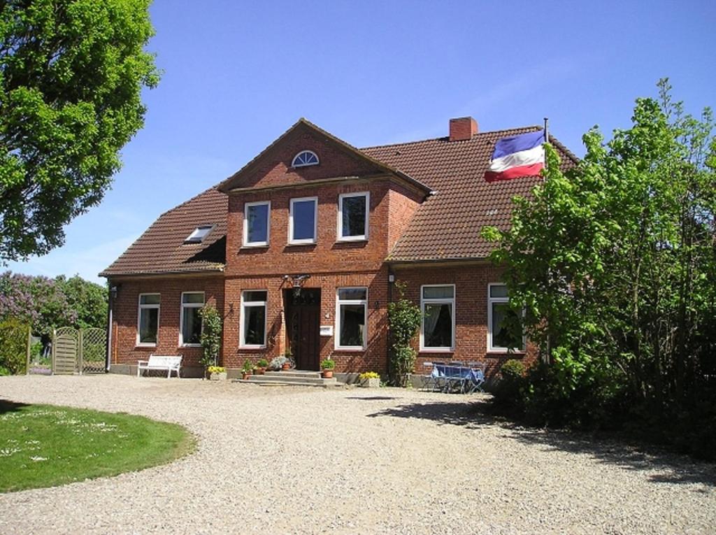 a large brick house with a roof at Ferienhof Albert in Gremersdorf