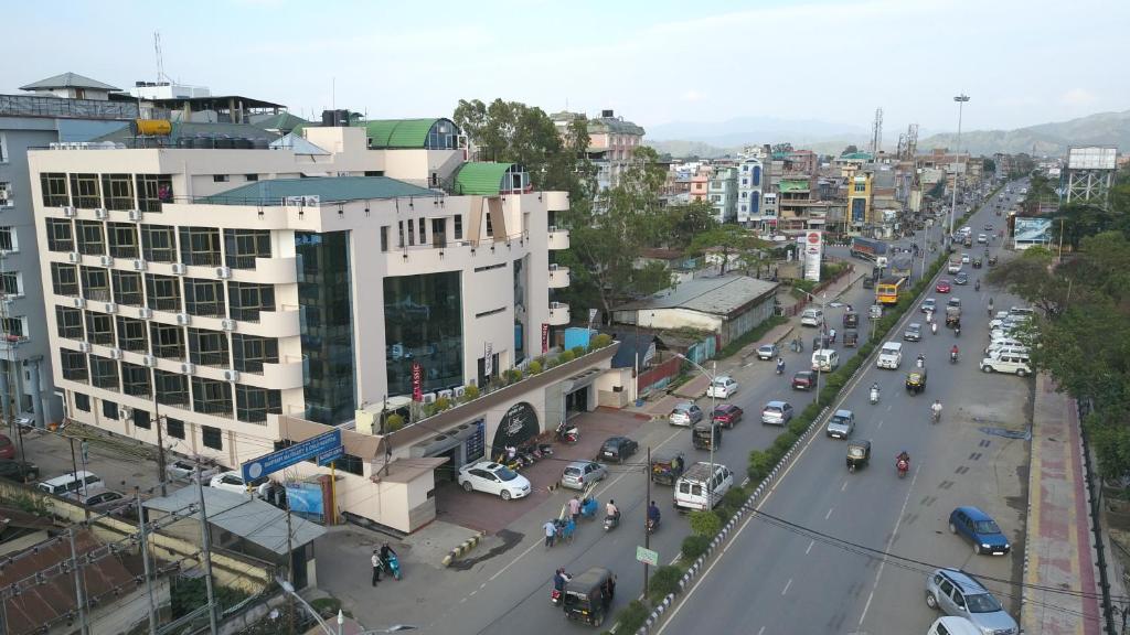 a busy city street with cars and vehicles on the road at The Classic Hotel in Imphal
