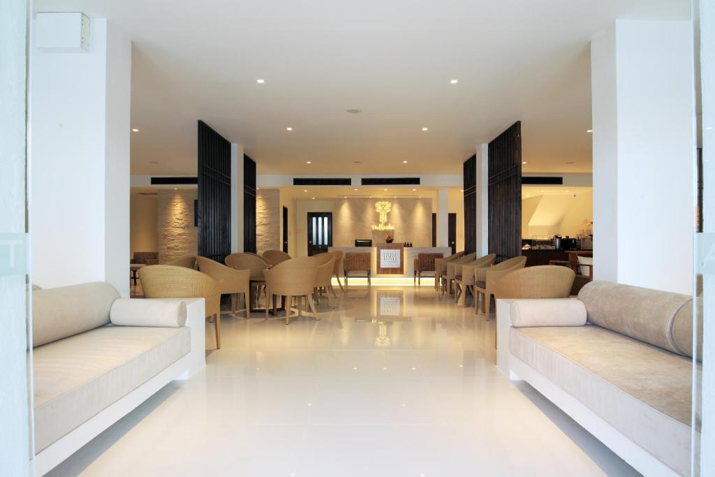 a living room with couches and a dining room at The Racha in Ko Racha Yai 