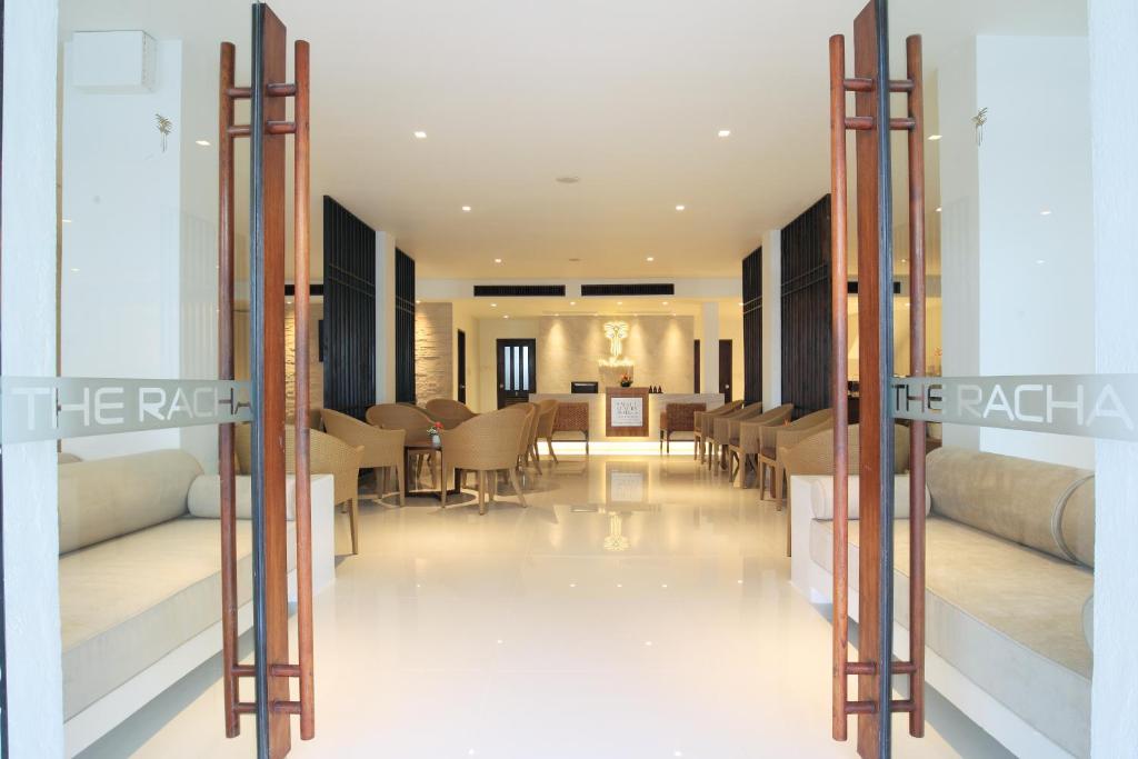 a lobby of a hotel with tables and chairs at The Racha in Ko Racha Yai 