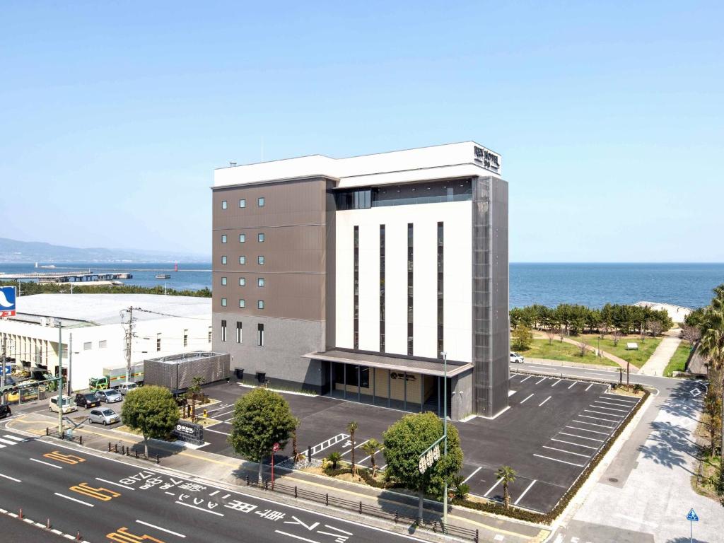 an aerial view of a building with a parking lot at REX HOTEL Beppu in Beppu