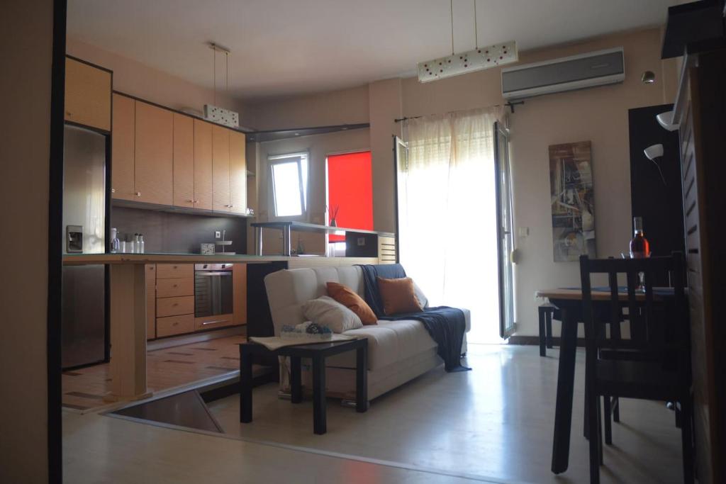a living room with a couch and a table at Modern apartment, 5΄ walk from central metro station in Athens