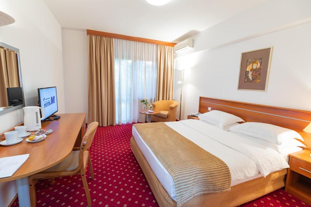 Postel nebo postele na pokoji v ubytování Hotel M