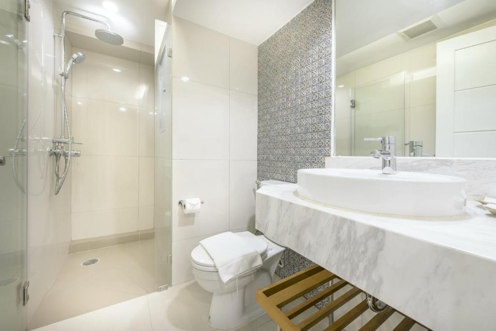 A polished bathroom with a glass-enclosed walk-in shower and vessel sink.
