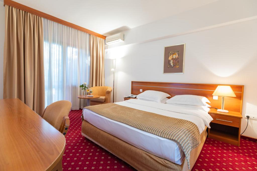 Postel nebo postele na pokoji v ubytování Hotel M