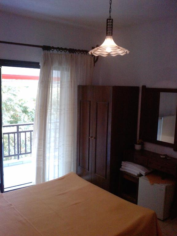 Postel nebo postele na pokoji v ubytování Hotel Lefkes