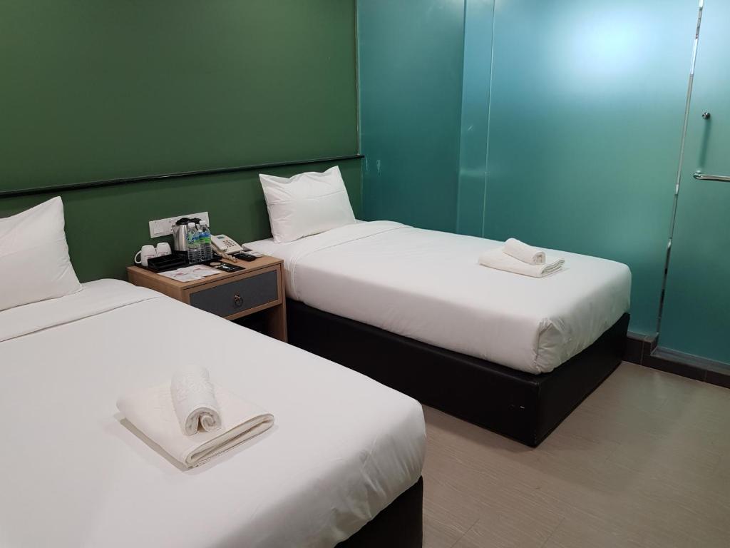 Postel nebo postele na pokoji v ubytování Bloommaze Boutique Hotel Klang