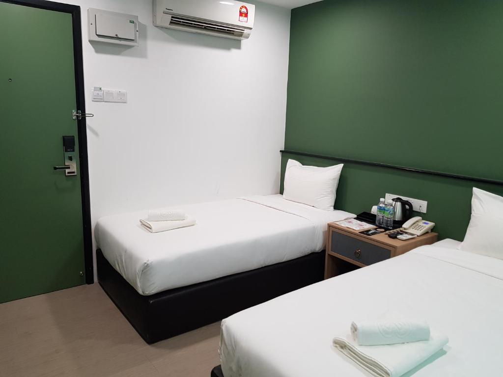 Postel nebo postele na pokoji v ubytování Bloommaze Boutique Hotel Klang