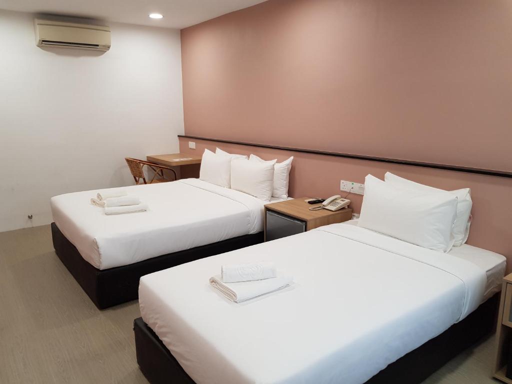Postel nebo postele na pokoji v ubytování Bloommaze Boutique Hotel Klang
