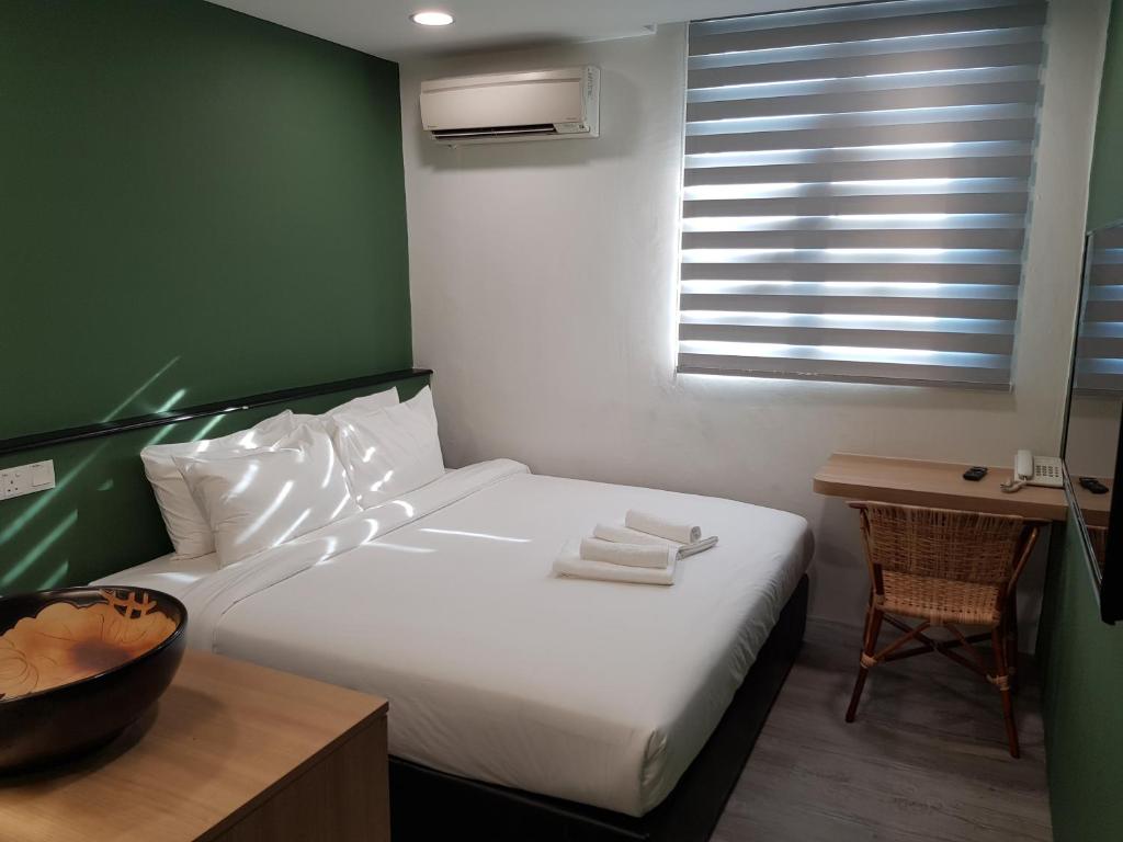 Postel nebo postele na pokoji v ubytování Bloommaze Boutique Hotel Klang