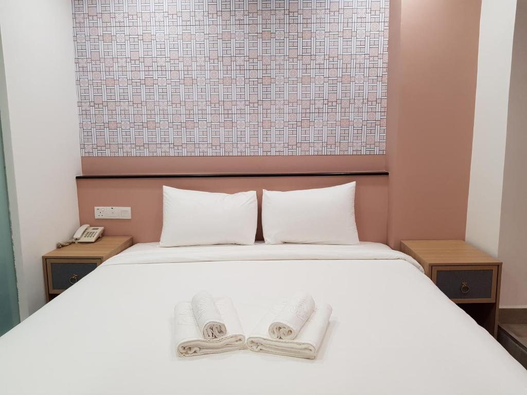 Postel nebo postele na pokoji v ubytování Bloommaze Boutique Hotel Klang