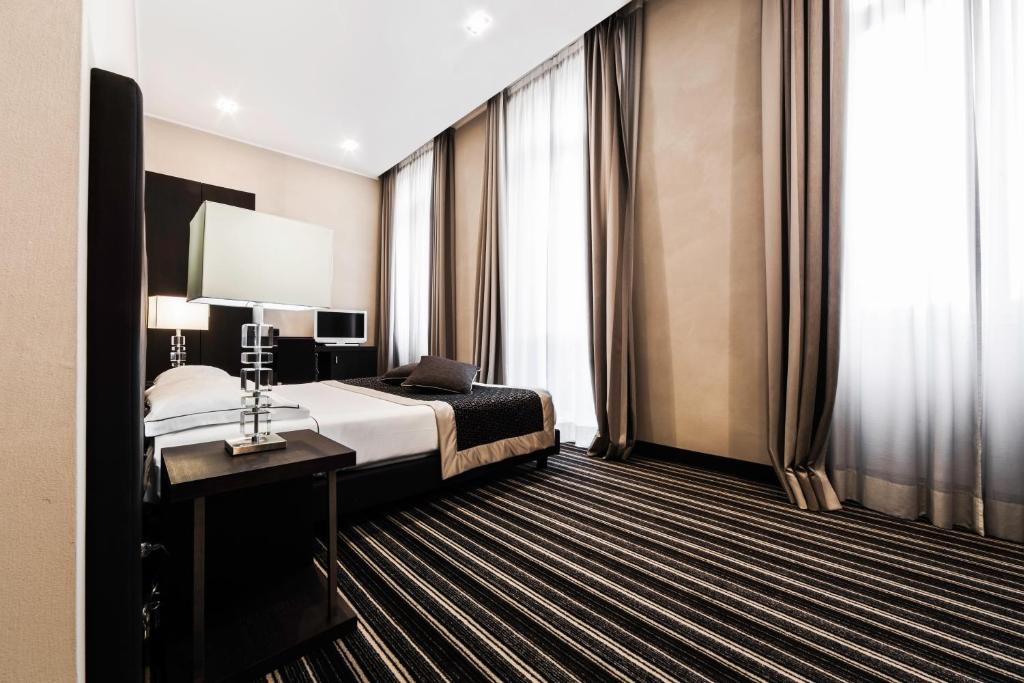 Postel nebo postele na pokoji v ubytování Hotel Principe Di Torino