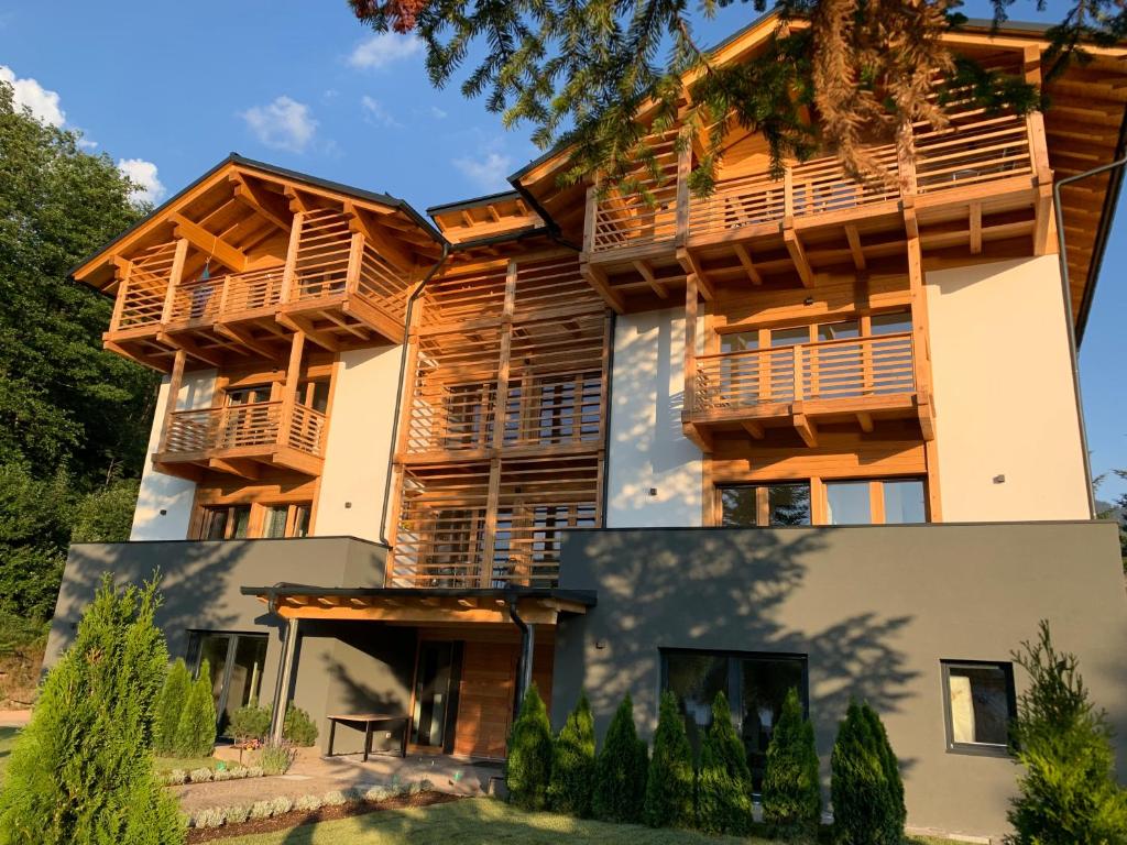 a house with balconies on the side of it at Affittacamere Casa Ester in Baselga di Pinè