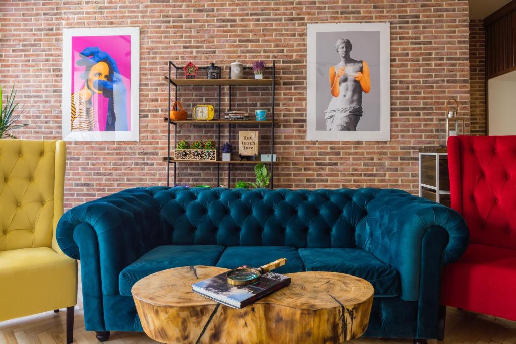 a living room with a blue couch and a wooden table at KievApts Maydan Apartments in Kyiv