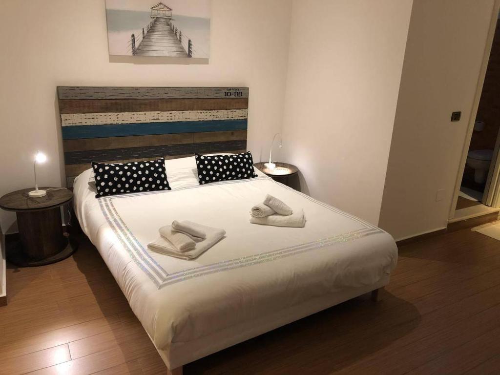 a bedroom with a bed with two shoes on it at Casa Mia! in Bari