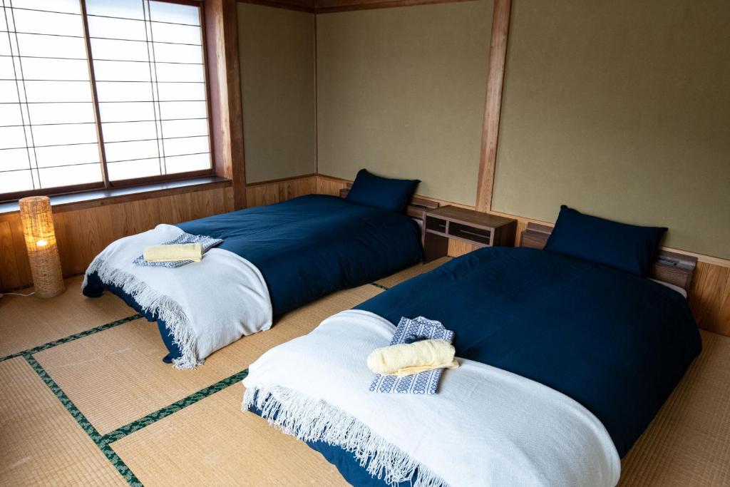 Postel nebo postele na pokoji v ubytování Toemu Nozawa Lodge