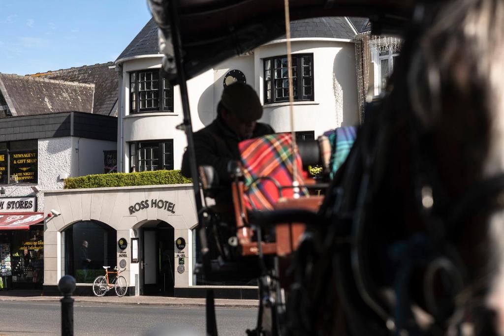 a man in a cart in front of a building at The Ross in Killarney