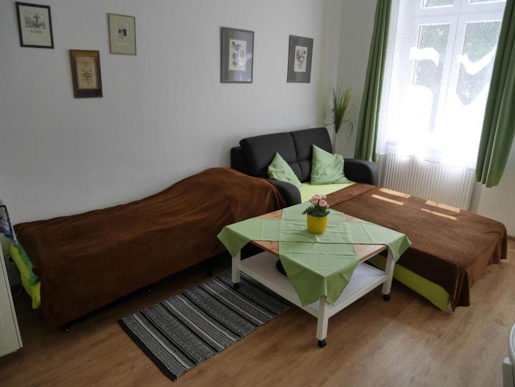 a living room with a bed and a table at Moskevská 40 in Karlovy Vary