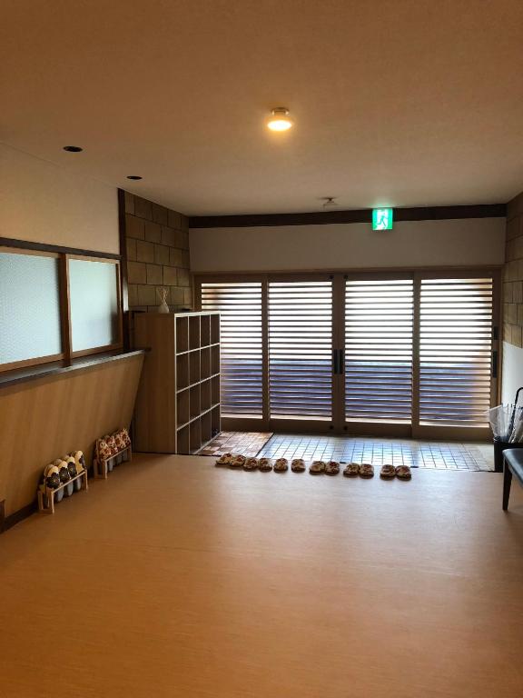 a room with a waiting room with shoes on the floor at Oyado Zen in Kusatsu
