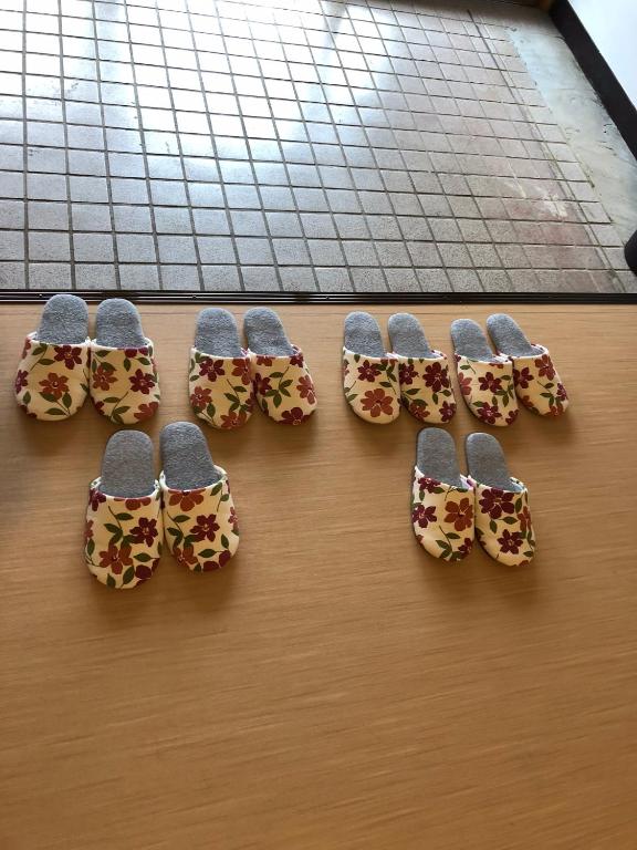 a group of five pairs of shoes on a table at Oyado Zen in Kusatsu