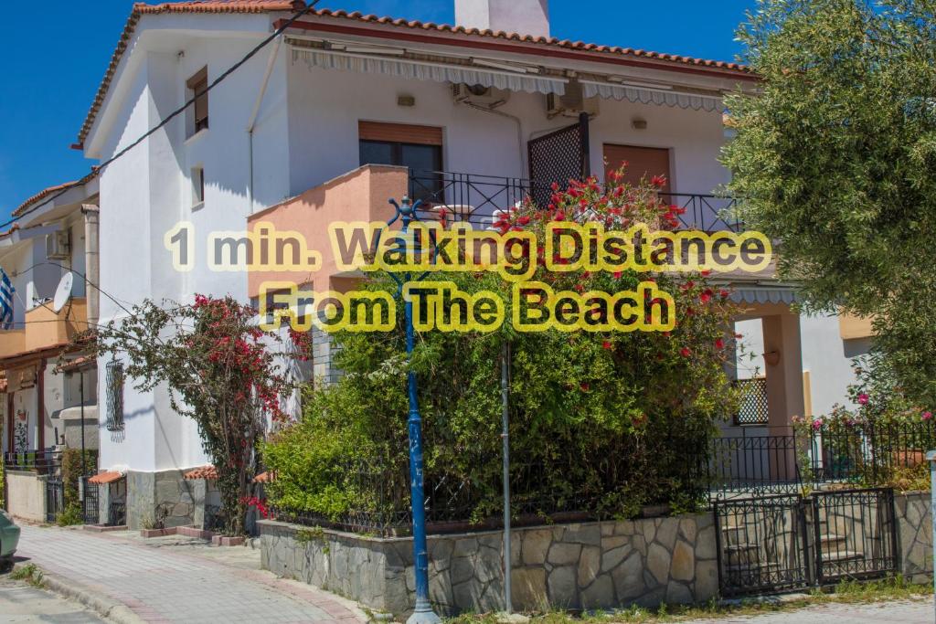 a sign that reads inn walking distance from the beach at Zoli house in Pefkochori