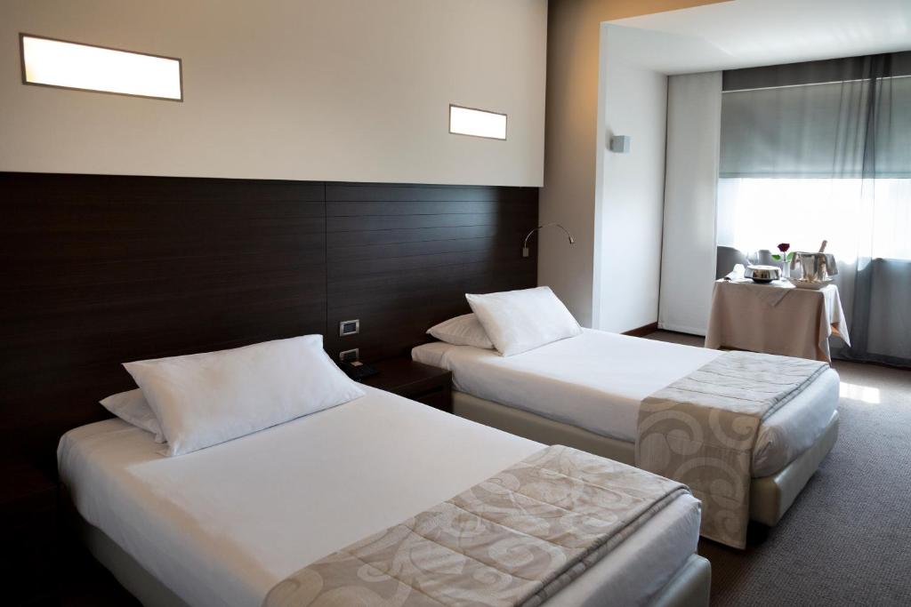 Postel nebo postele na pokoji v ubytování Hotel Selene Pomezia