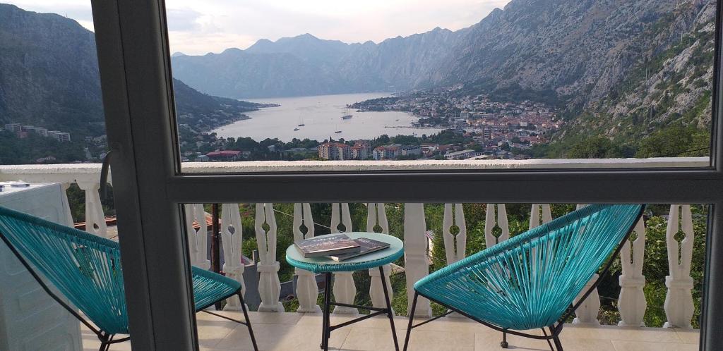 a view from a balcony with two chairs and a table at Beautiful view in Kotor