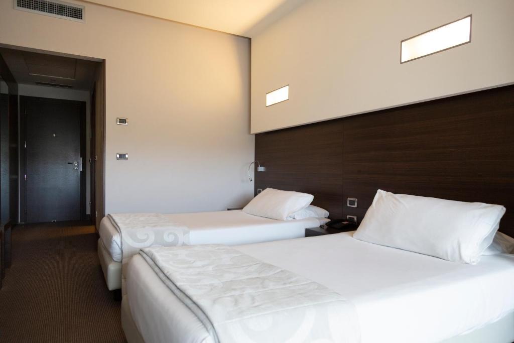 Postel nebo postele na pokoji v ubytování Hotel Selene Pomezia