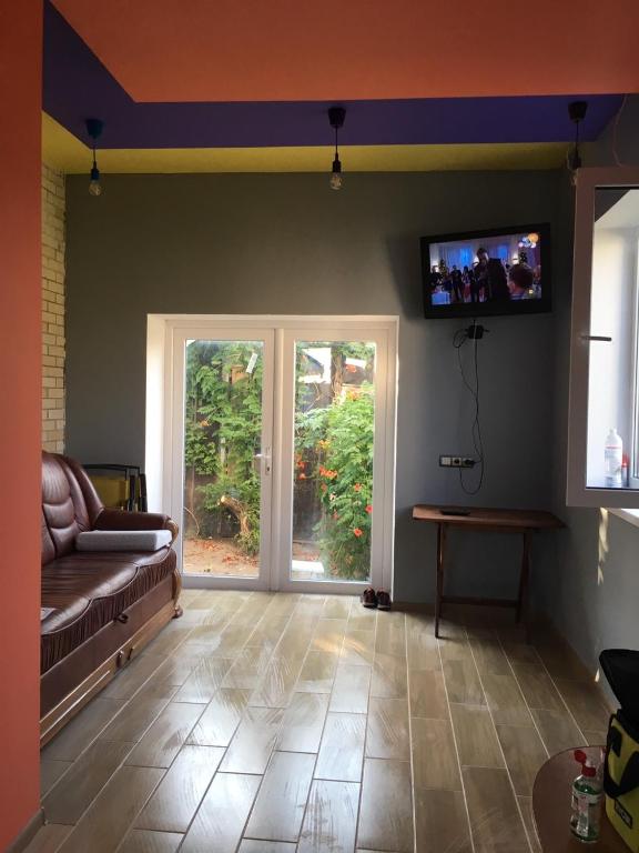 a living room with a couch and a sliding glass door at Villa Bulli in Zatoka