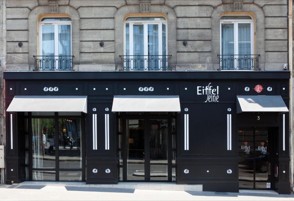 a building with a sign on the front of it at Hotel Eiffel Seine in Paris