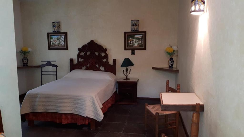 Postel nebo postele na pokoji v ubytování Hotel No Que No