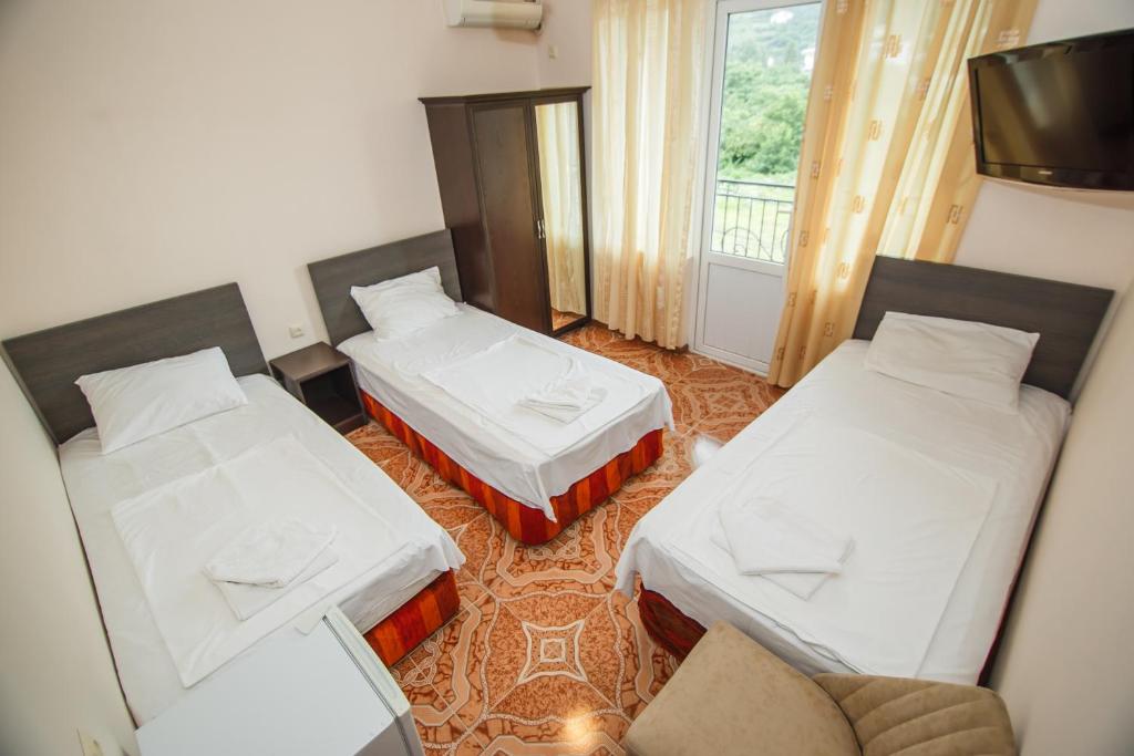 Postel nebo postele na pokoji v ubytování Guest House Nia